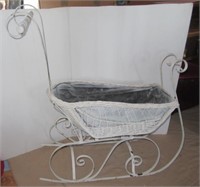 Wicker doll buggy with metal base. Measures 37" h
