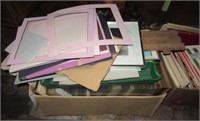 Large box filled with various frames, mat boards,