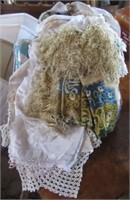 Bag of vintage linens including doilies, table