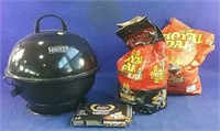 Charcoal backyard grill with charcoal briquettes