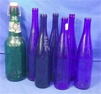 1 Large Grolsch bottles and 6 blue wine bottles