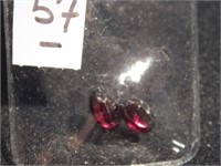 Two faceted oval garnet gemstones - one is 8 mm