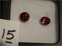 Two Ruby gemstones - one round, one oval - both
