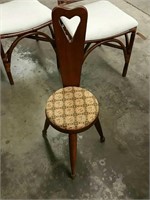 Three-legged chair with heart shaped back
