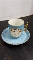Miniature blue porcelain tea cup and saucer