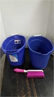 Two cleaning buckets and pink broom