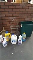 Household cleaning supplies and trash can