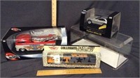 (3) DIE CAST CARS AND (1) DISPLAY CASE