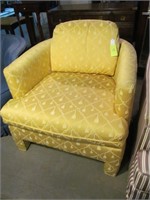 Yellow upholstered chair, tassel design fabric
