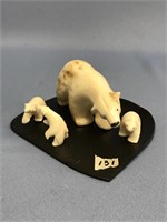 Fossilized and white ivory polar bear sow with 3 c