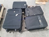 4 black suit cases
