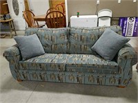 Blue and gray pattern hide a bed couch.