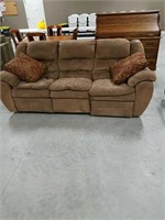 Double recliner couch, brown in  color.