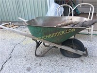 Old green paint metal wheel barrow