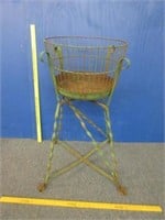 antique green wire basket on metal stand