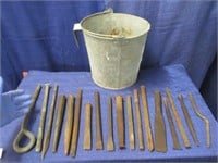 calf bucket with various iron chisels