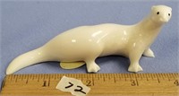 4" fossilized ivory carving of an otter with inset