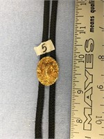 Wonderful gold nuggeted ram bolo tie with fossiliz