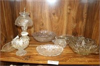 Shelf of Glass Items and Lamp