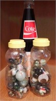 (2) small jars of marbles and 1983 Orioles