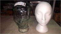 Pair of woman mannequin heads one is glass one is