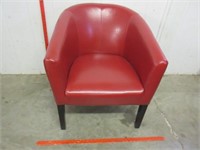 nice red club chair on legs (partially leather)