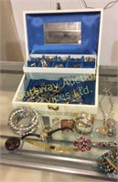 Jewelry box filled with assorted jewelry