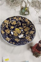 Blue/gold dish with relief pattern of flowers.