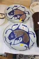 2 glazed bowls decorated with fish.