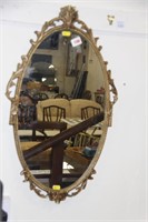 Oval hilt frame mirror.