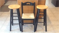 Two barstools and a wicker seat chair.