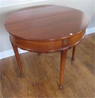 Unique gate leg side table with one drop-leaf.