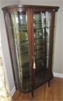Antique curved glass china cabinet on wood