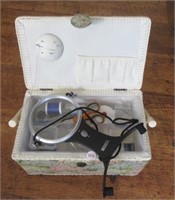 Sewing box with various sewing supplies.
