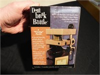 "A pressing puzzle"  wood vise to open a bottle