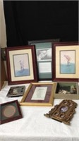 Group of framed artwork and picture frames