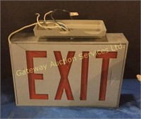 Exit sign with electrical and plumbing fixtures