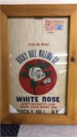 Wood framed white rose flour sack.