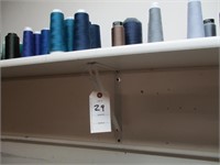 Shelf of large spools of thread