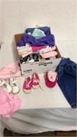 Group of baby girl clothes and shoes