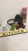 Kitchen sign, grapes, tins, hanging teacup with