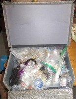Box full of costume jewelry including necklaces,