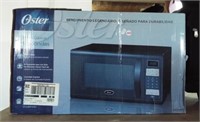 Oster microwave with box.