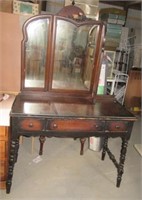 Vintage wood vanity with trifold mirror and three