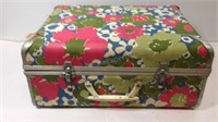 Flowered vintage suitcase filled with goodies