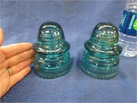 2 blue glass insulators