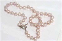 Pink pearl necklace with heart shaped silver clasp