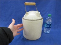 old cream stone jug with wooden handle (chips)