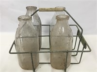 Vintage milk bottles with carrier.