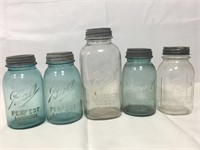 Five vintage Mason jars.